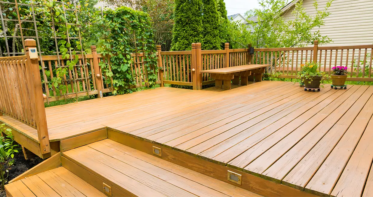 A wooden deck with benches and stairs.